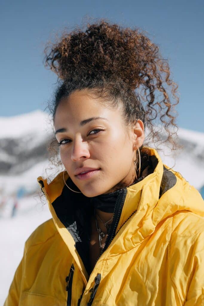 Pineapple bun ski hairstyle showing curly hair volume