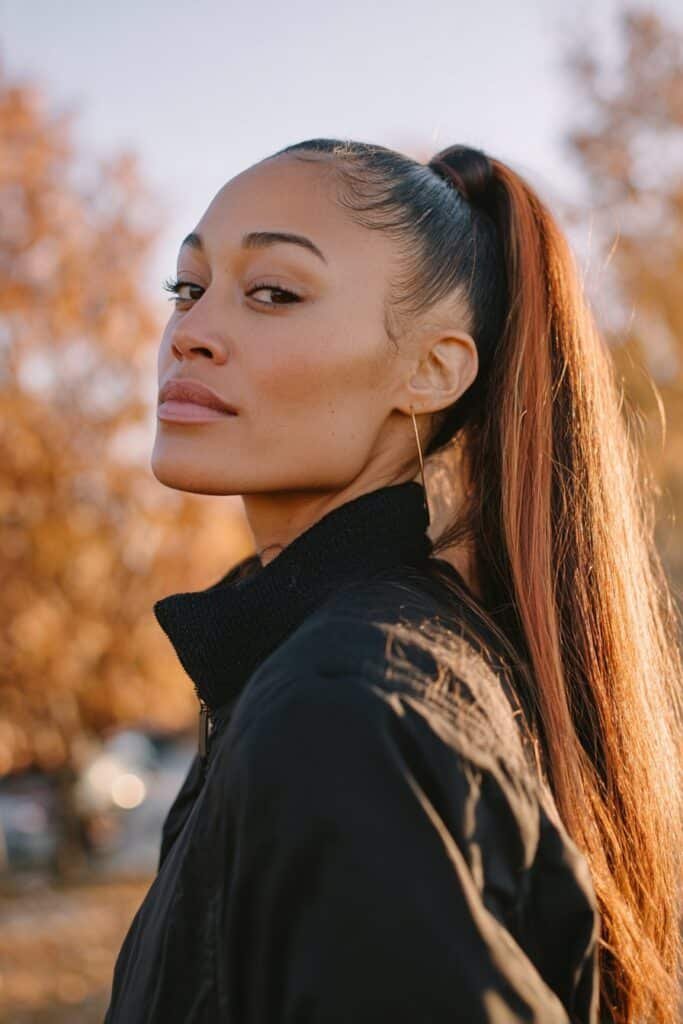 sleek high ponytail with pumpkin spice peekaboo highlights underneath