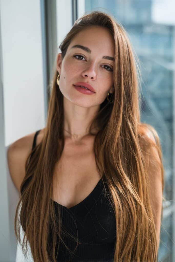 Sleek straight side part hairstyle for long hair with smooth silky strands