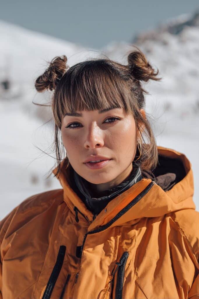 Space buns with straight bangs in winter setting