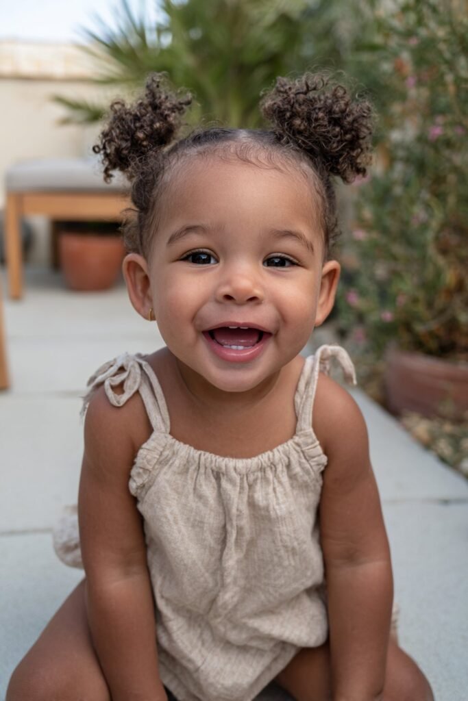 infant baby girl hairstyle with small natural curly affros