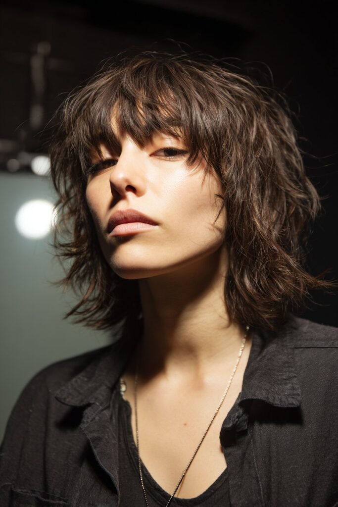 woman with rock and roll shag haircut and choppy fringe