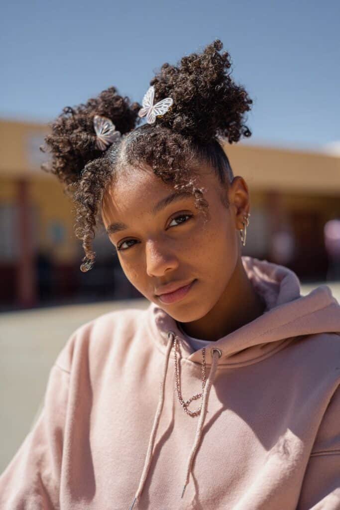 Black woman wearing twist outs styled with butterfly clips.