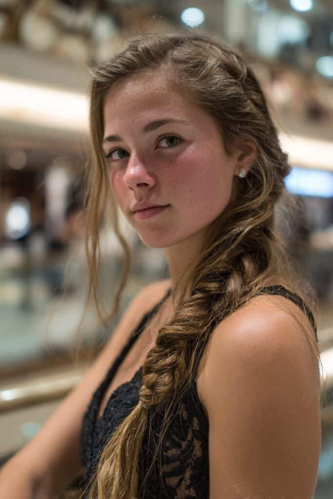 Teen girl wearing a cascading side braid prom hairstyle for long fine hair.