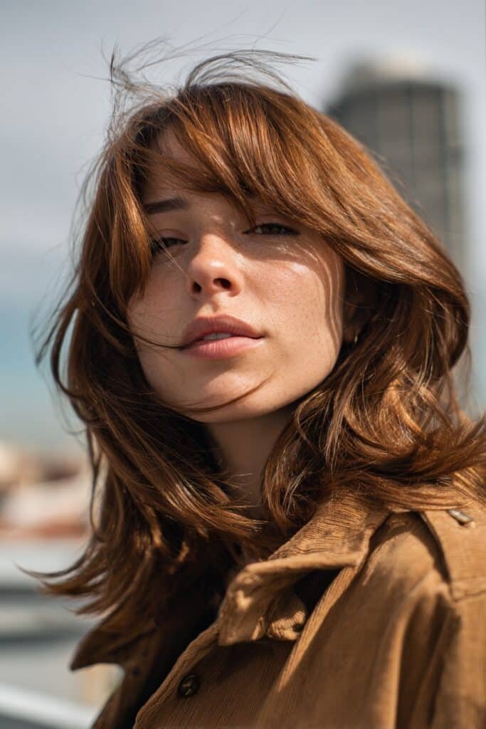 Chestnut shag haircut with layered texture and airy movement.