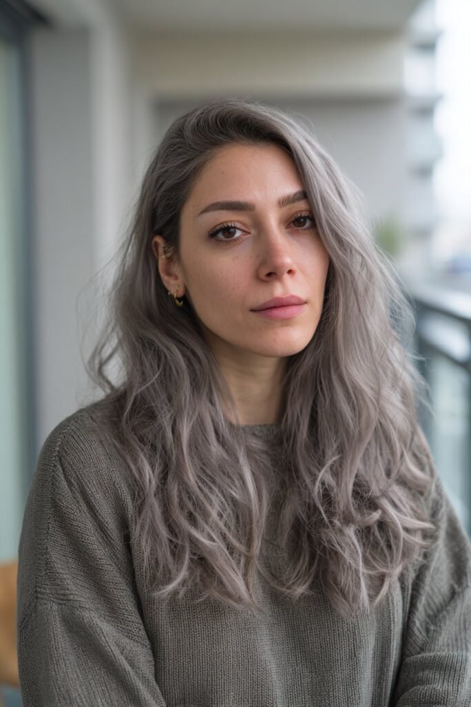 Woman with cool taupe lowlights blended naturally.