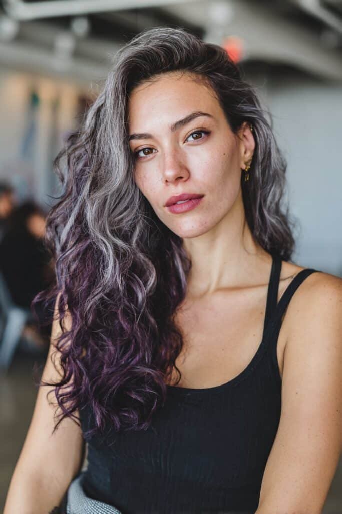 Woman showing deep plum lowlights in gray hair.