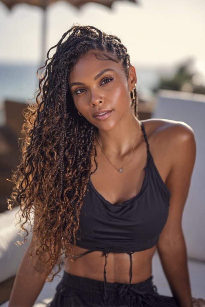 Woman with knotless box braids blended with beachy curls.