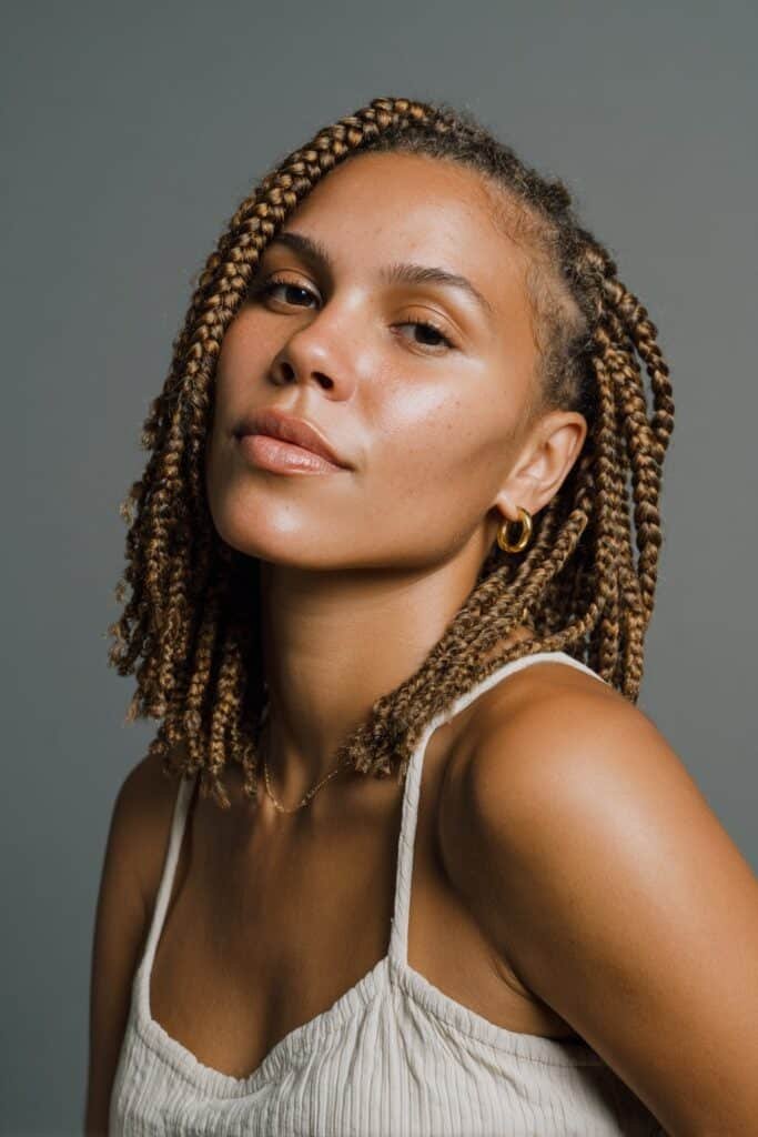 Woman with shoulder-length cassie braids and tidy sections.