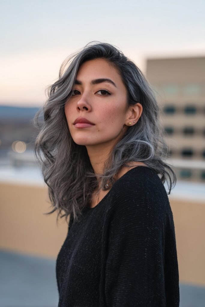 Woman showing smoky charcoal lowlights on gray hair.