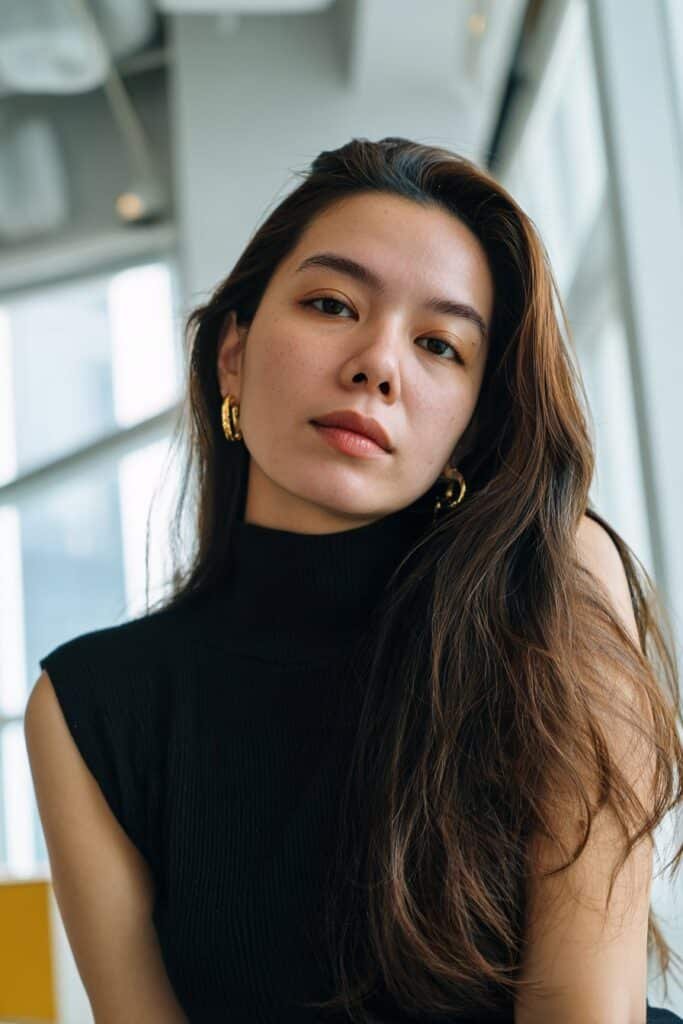 Woman wearing soft black lowlights for sleek contrast.