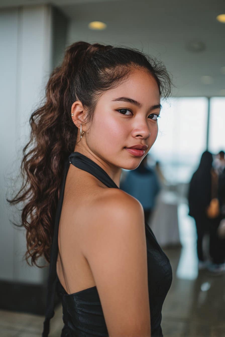 Teen girl with textured ponytail and wrapped base for a modern prom look.