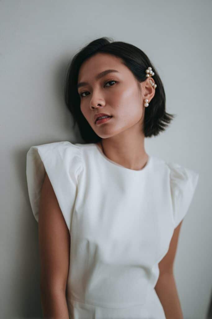 Bride with a side-pinned bob featuring elegant pearl accents.
