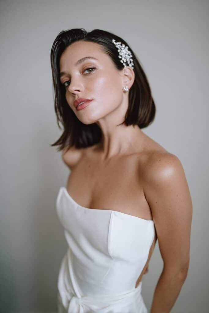 Engagement hairstyle for short hair with a sleek bob and deep side part.