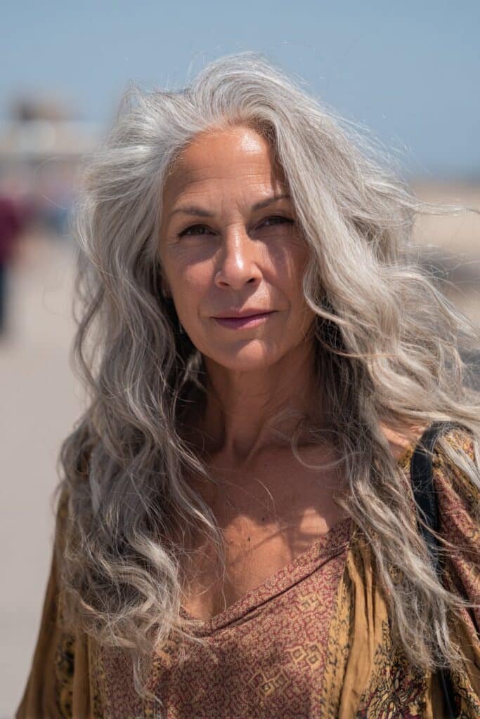 Older woman with voluminous boho waves long hairstyle.