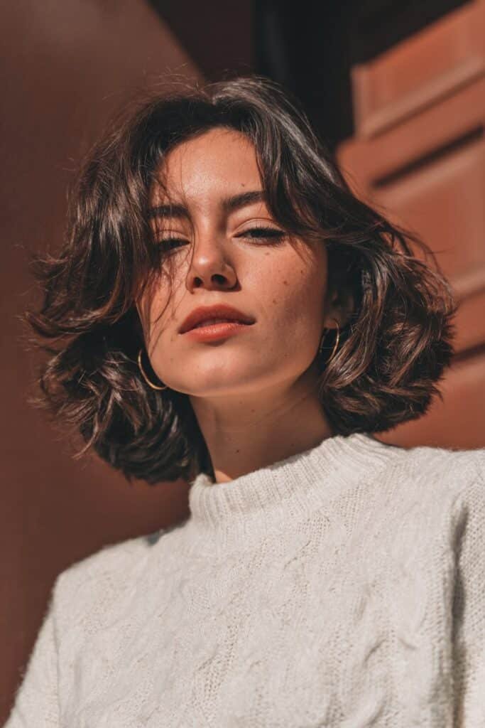 Voluminous feathered bob with rounded layers and retro volume.