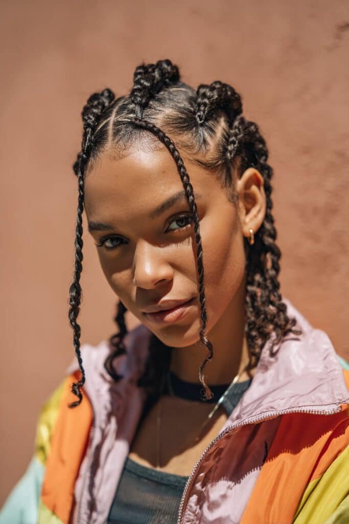 Black woman with zigzag part box braids and neat sections.