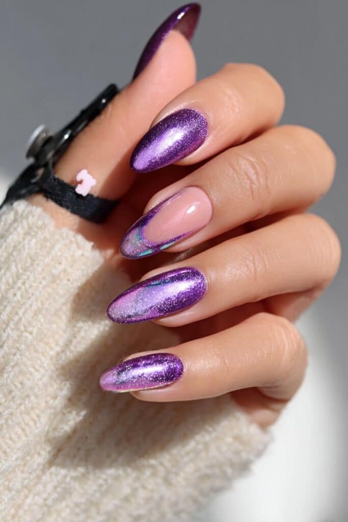 Amethyst aurora almond nails with glowing iridescent purple shine, full hand with fingers curved inward.