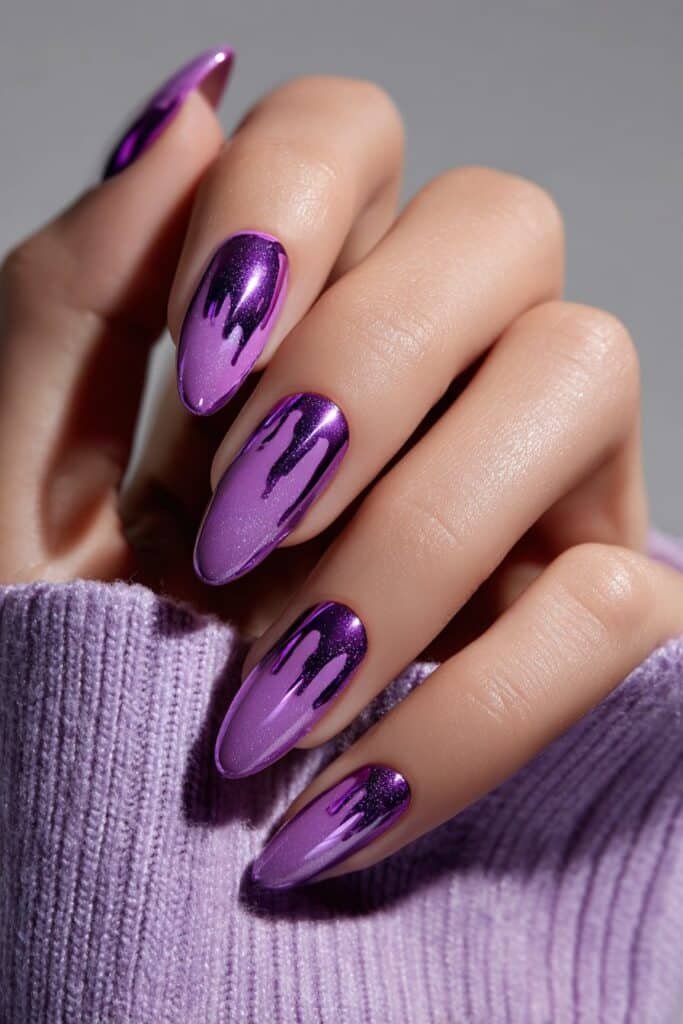 Amethyst drip almond nails with glossy purple dripping nail art design, full hand with fingers curved inward.