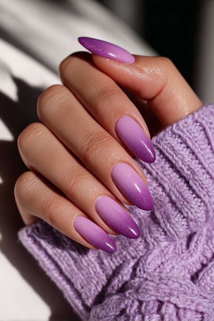 Almond-shaped nails with a rich violet to lavender ombre gradient.