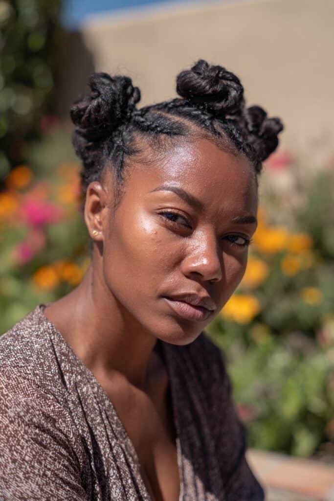 Black woman with bantu knots wig updo hairstyle for Black women.