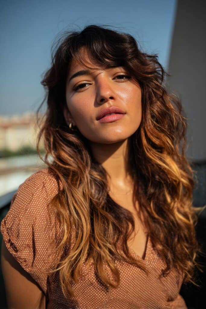 woman with dark brown hair and soft caramel highlights