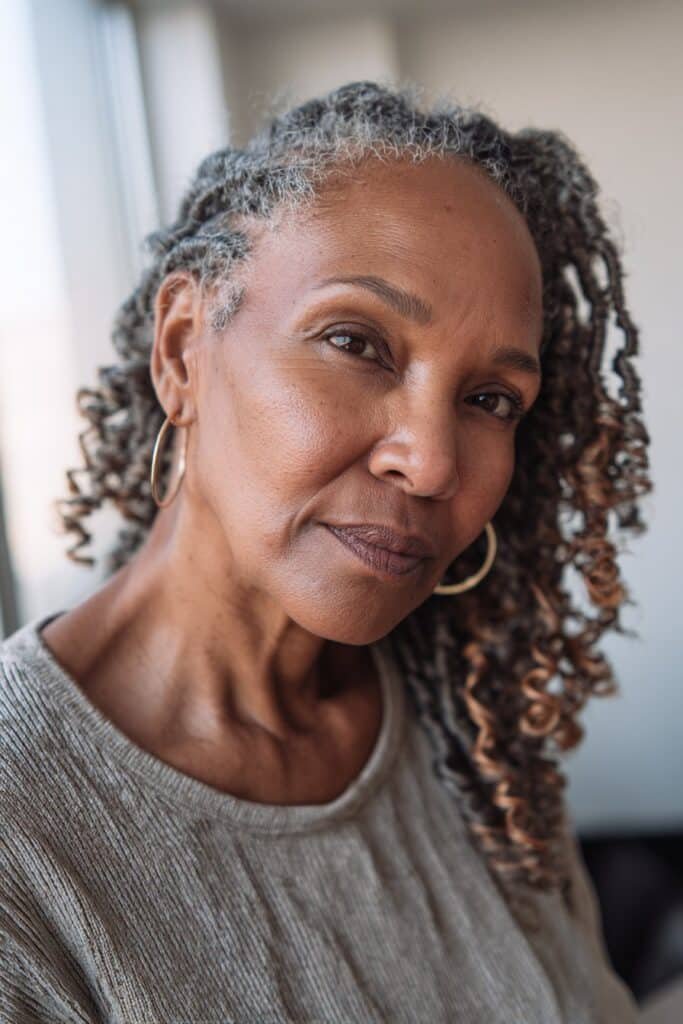 Older Black woman with crochet braids and soft curly volume