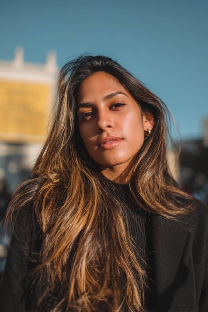 woman with dark brown hair and golden brown highlights