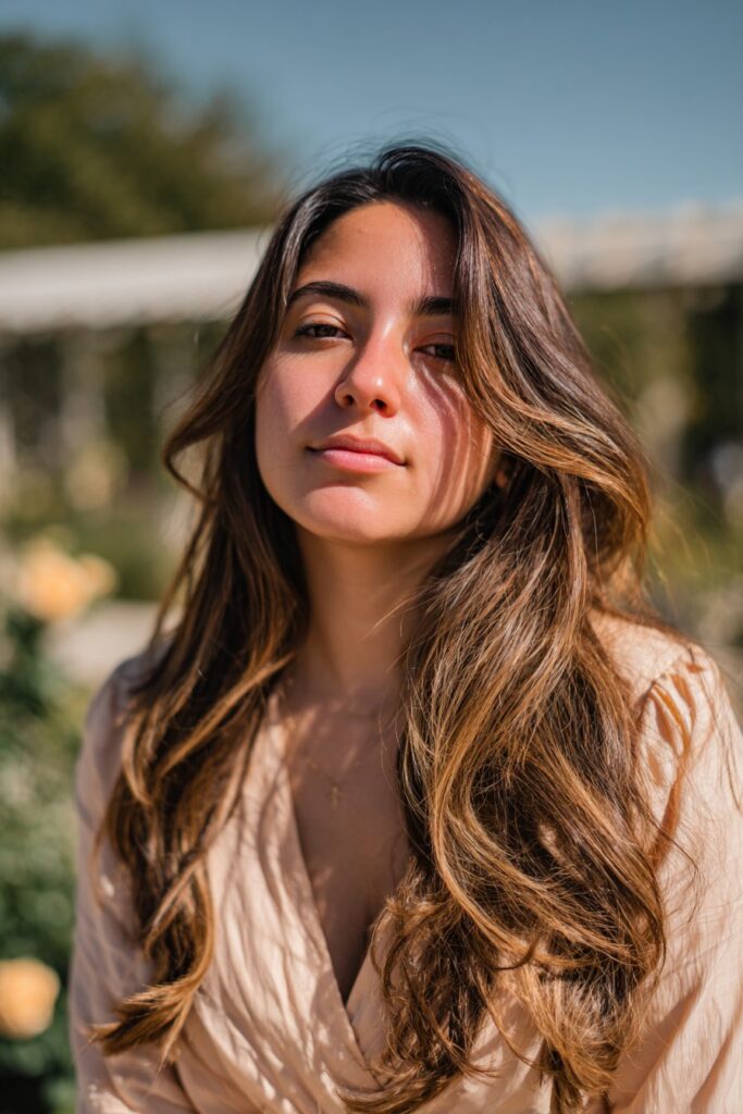woman with dark brown hair and honey blonde highlights