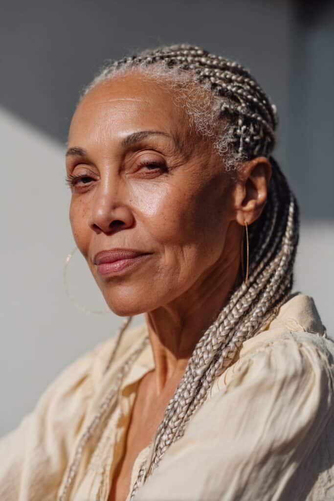 Older Black woman with fine micro braids and soft detailed texture