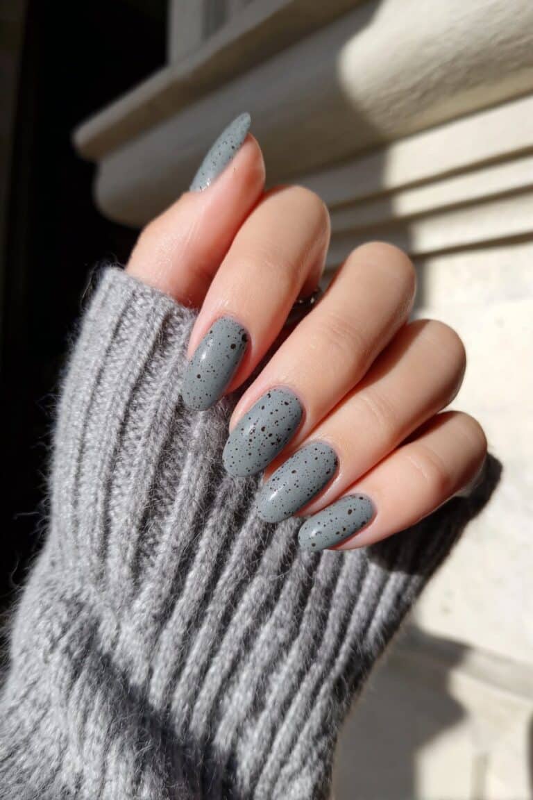 Robin egg silver nails with subtle black speckled effect.