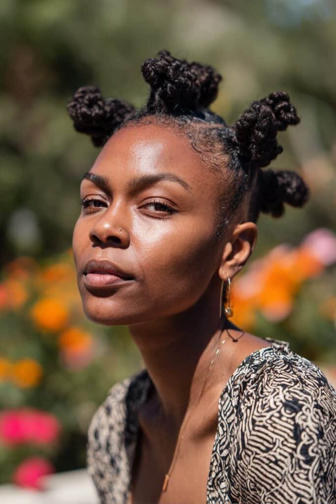 Black woman with twisted bantu knot updo hairstyle.