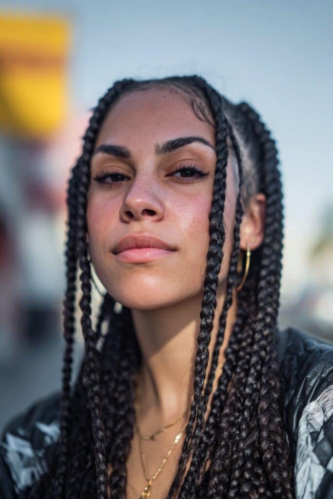 woman with box braids hairstyle, neat parted braids