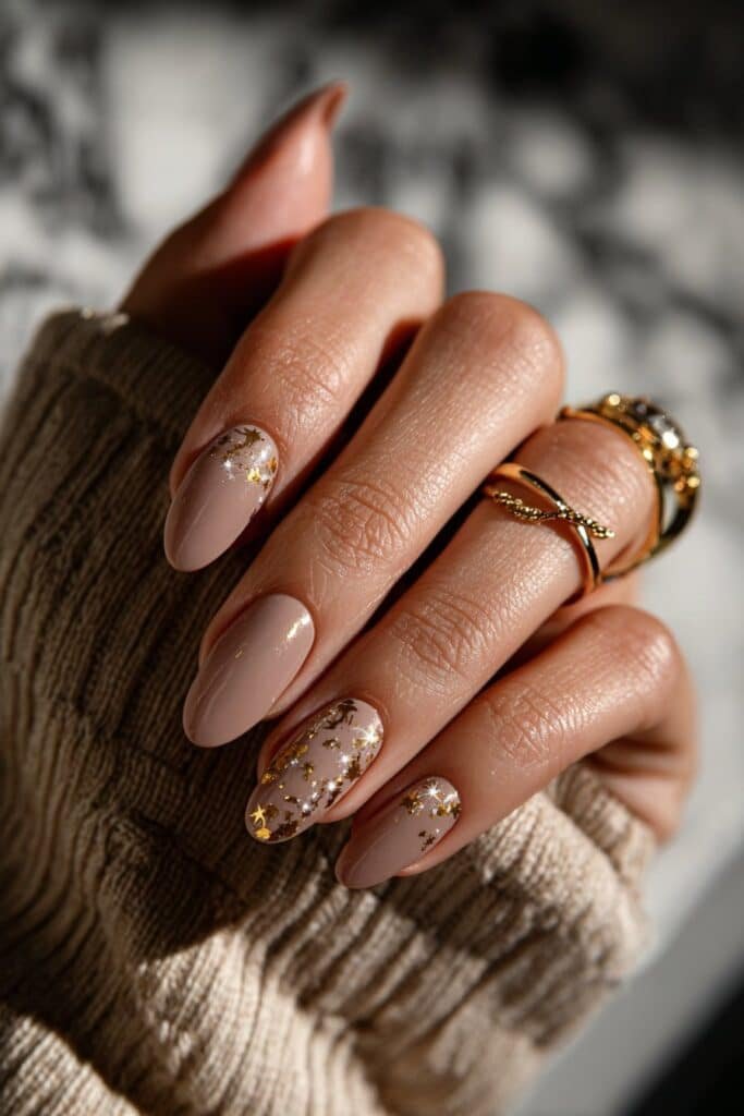 Nails with gold bull symbol and star constellation details.