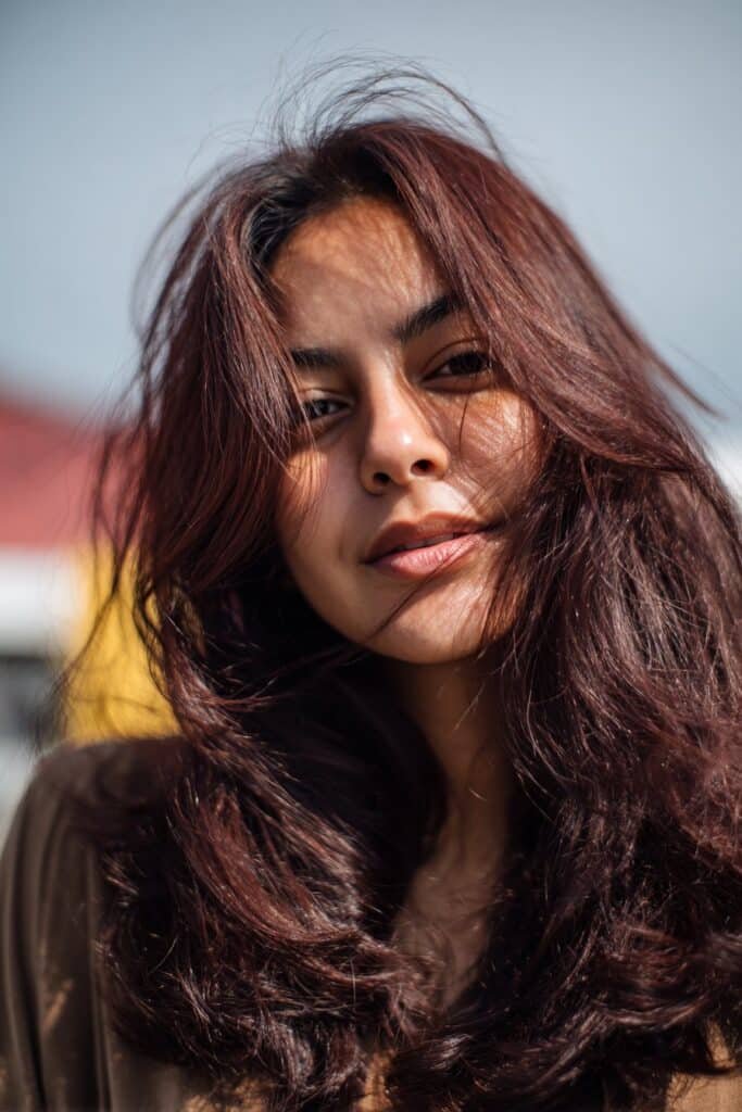 dark brunette hair with subtle chocolate cherry red undertones