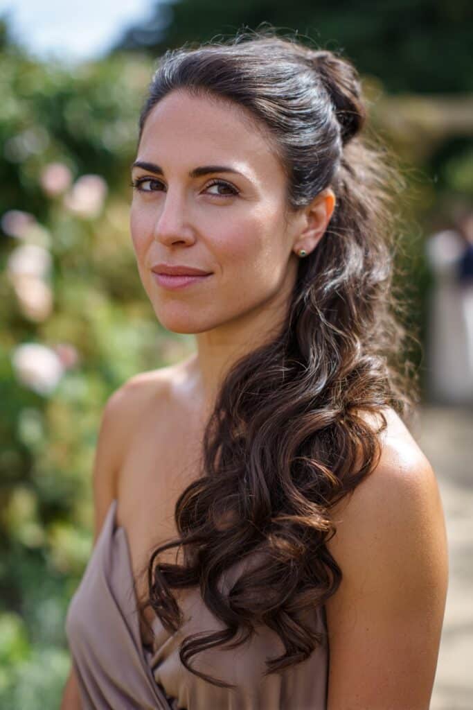 bridesmaid with half up half down hairstyle and long curls