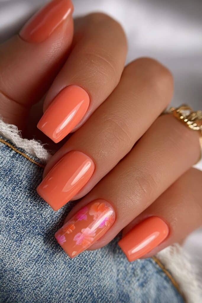 Coral square nails with warm sunset-inspired tones.