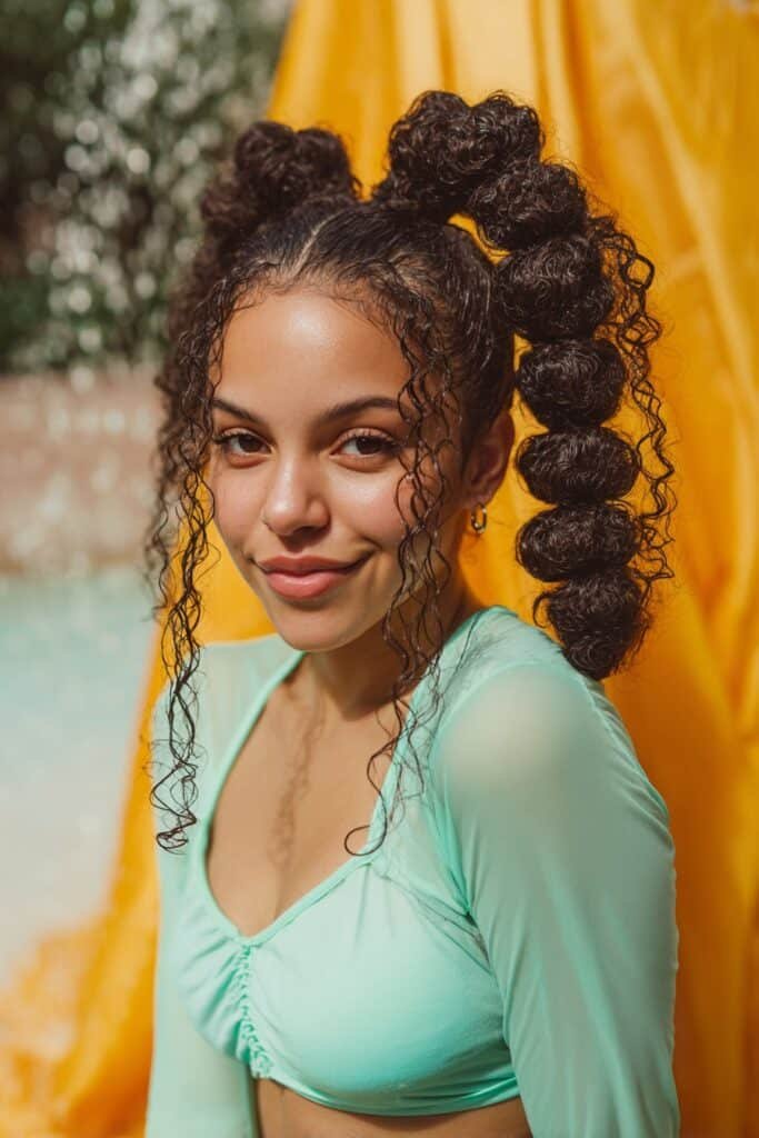curly bubble ponytail with voluminous sections on long hair