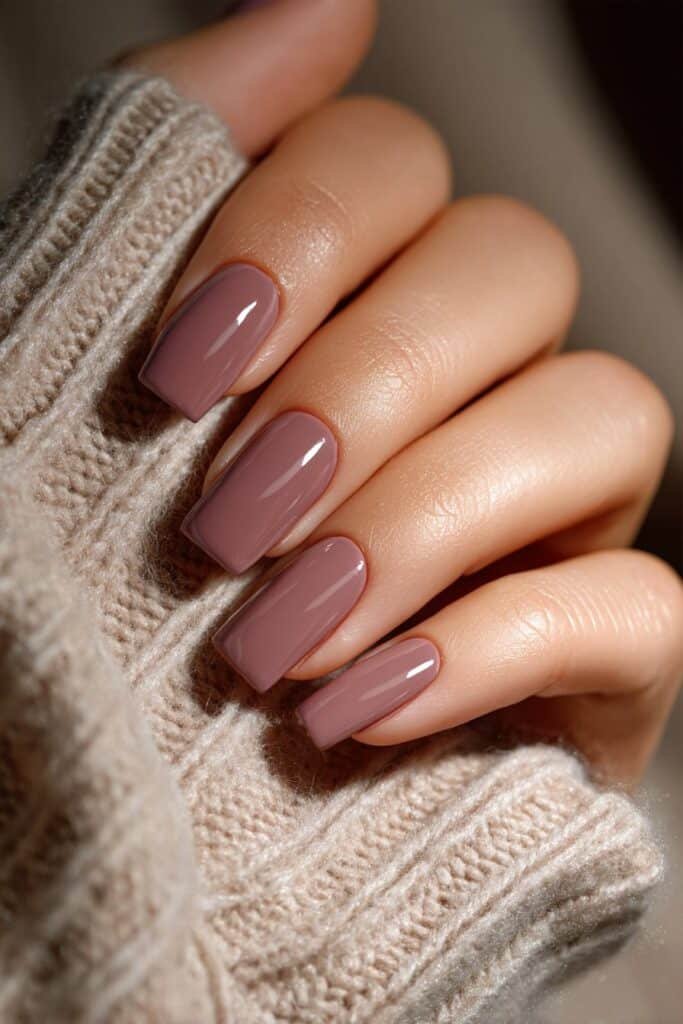 Dusty mauve nails with soft muted tone and glossy finish.