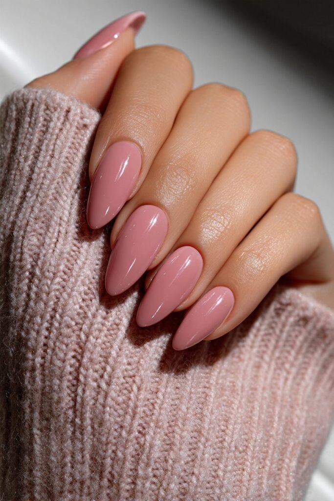 Dusty rose almond nails with modern negative space design.