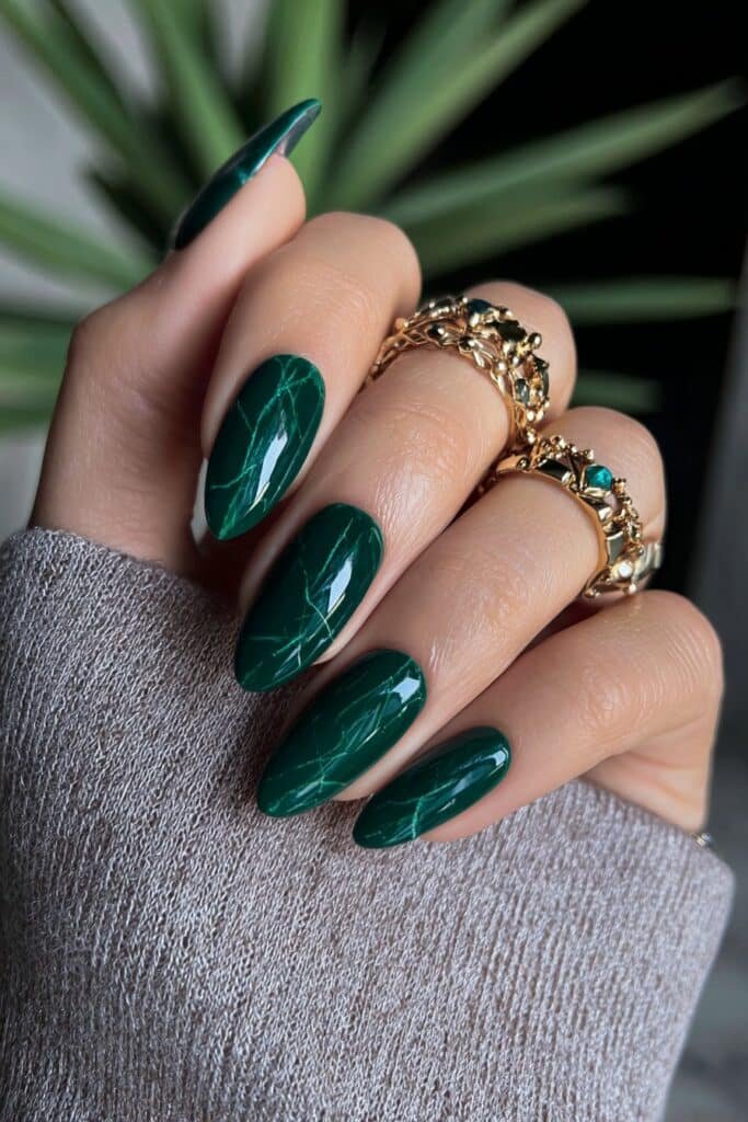 Rich emerald green nails with glossy finish and bold color.