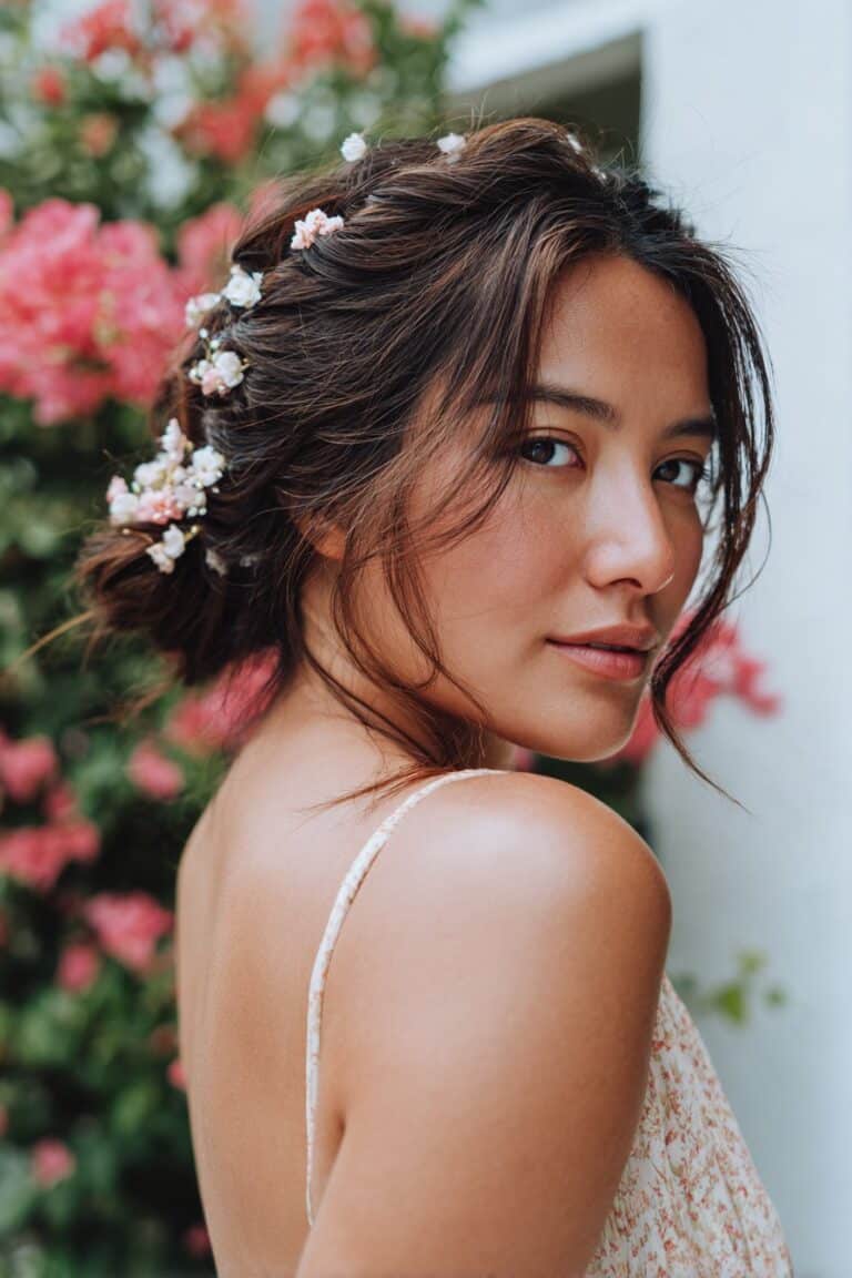 bridesmaid with floral pinned updo and soft romantic look