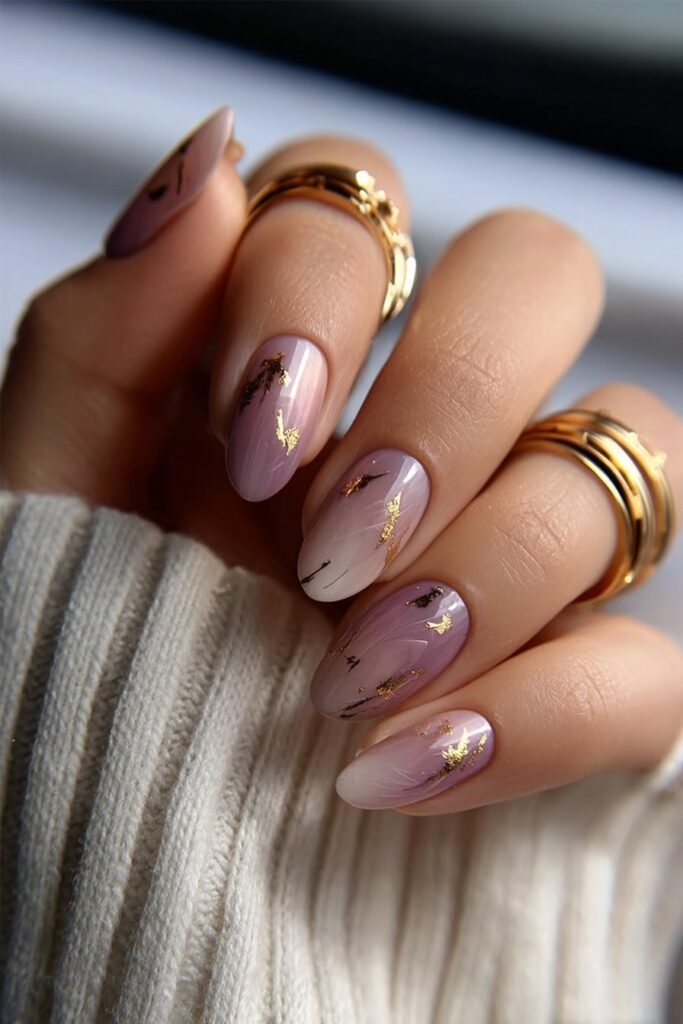 Almond nails with abstract gold foil accents.