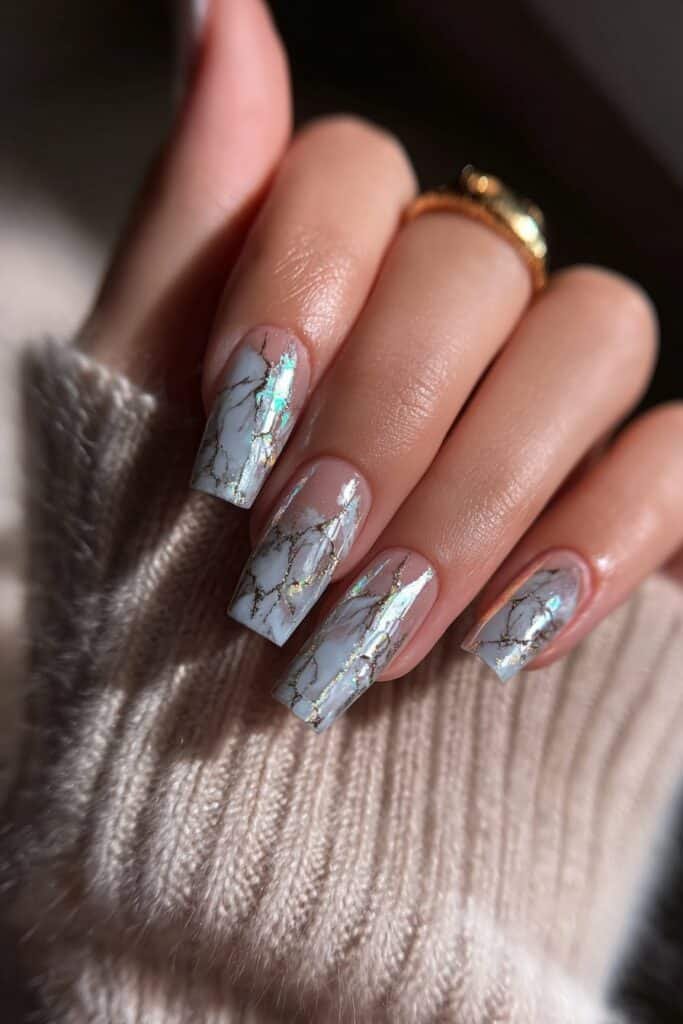 Square nails with holographic chrome shine and rainbow reflection.