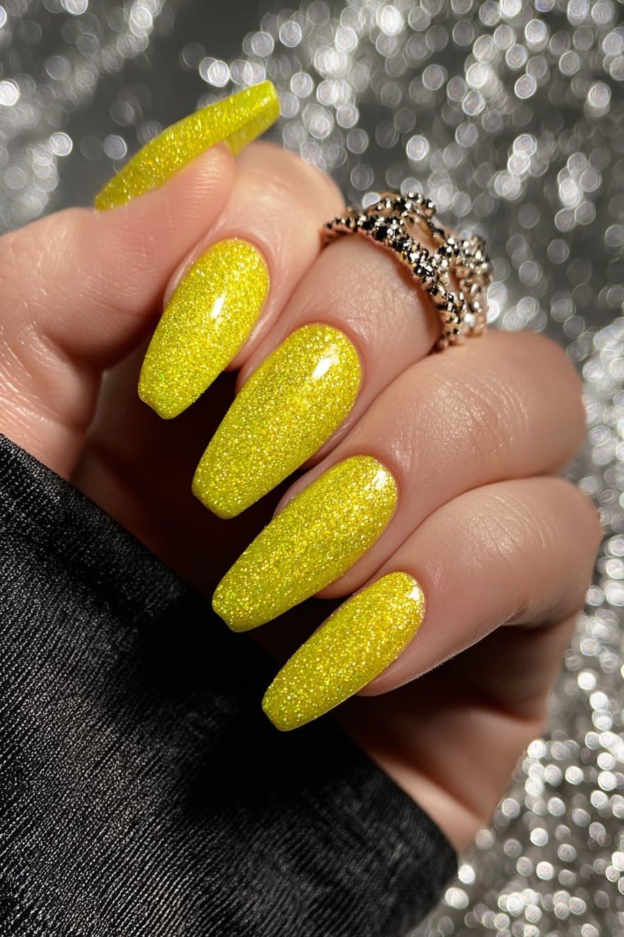 Sparkling lemon yellow glitter nails with full shimmer coverage.