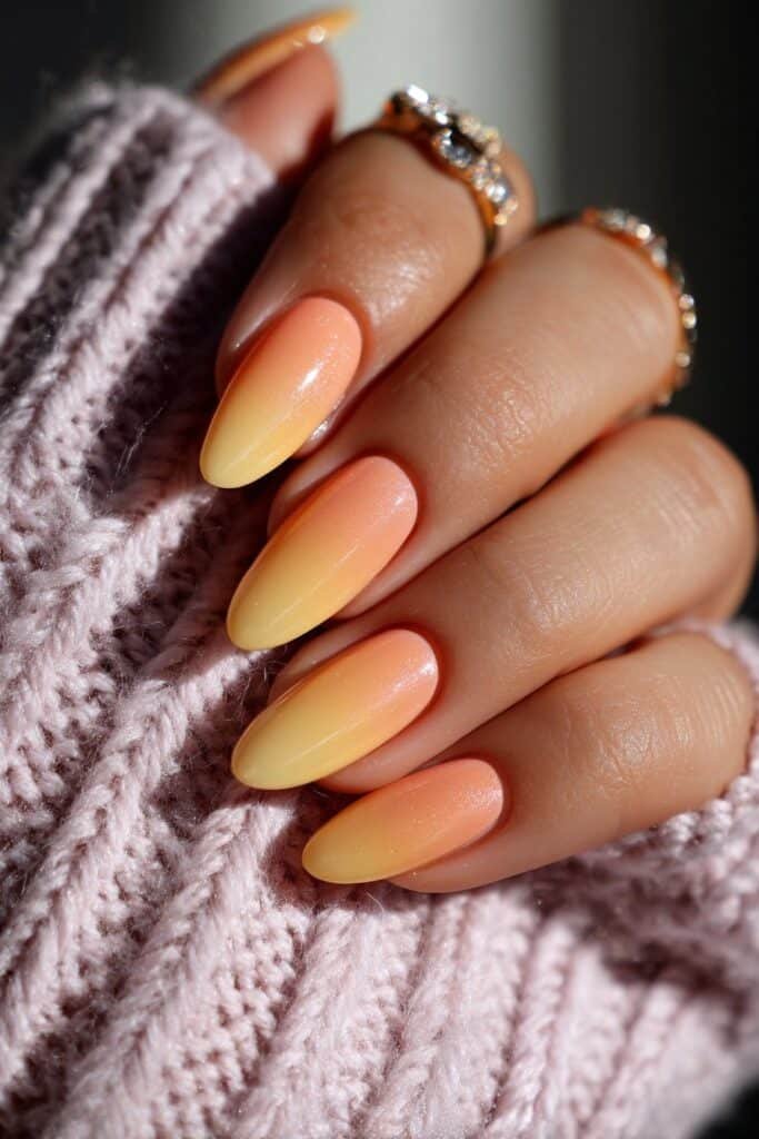 Lemon yellow to peach ombre nails with a smooth sunset gradient.