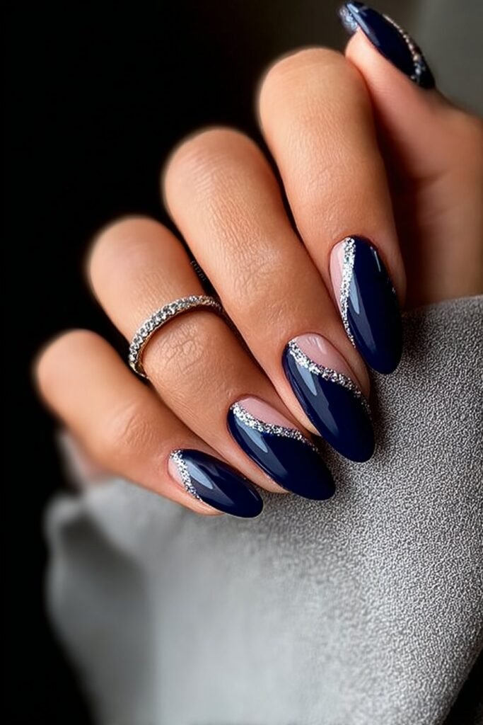 Navy blue nails with delicate silver accents and shimmer.