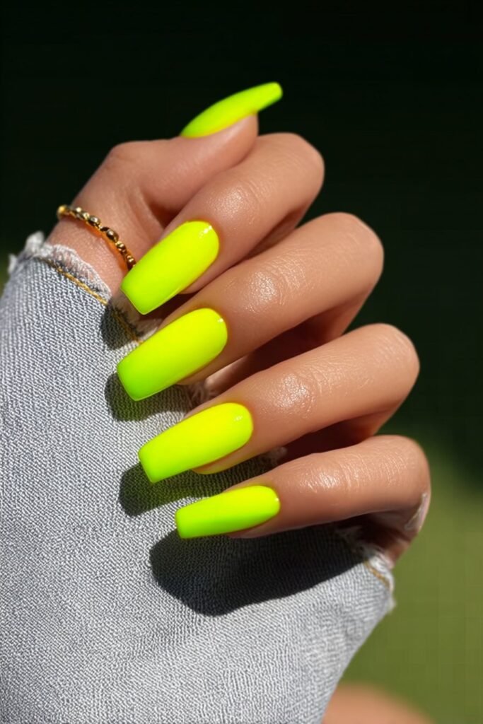Neon lemon yellow nails with bold glossy finish and vibrant color.