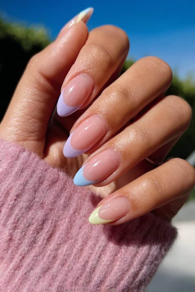 Almond nails with pastel French tips in pink, mint, and lavender.