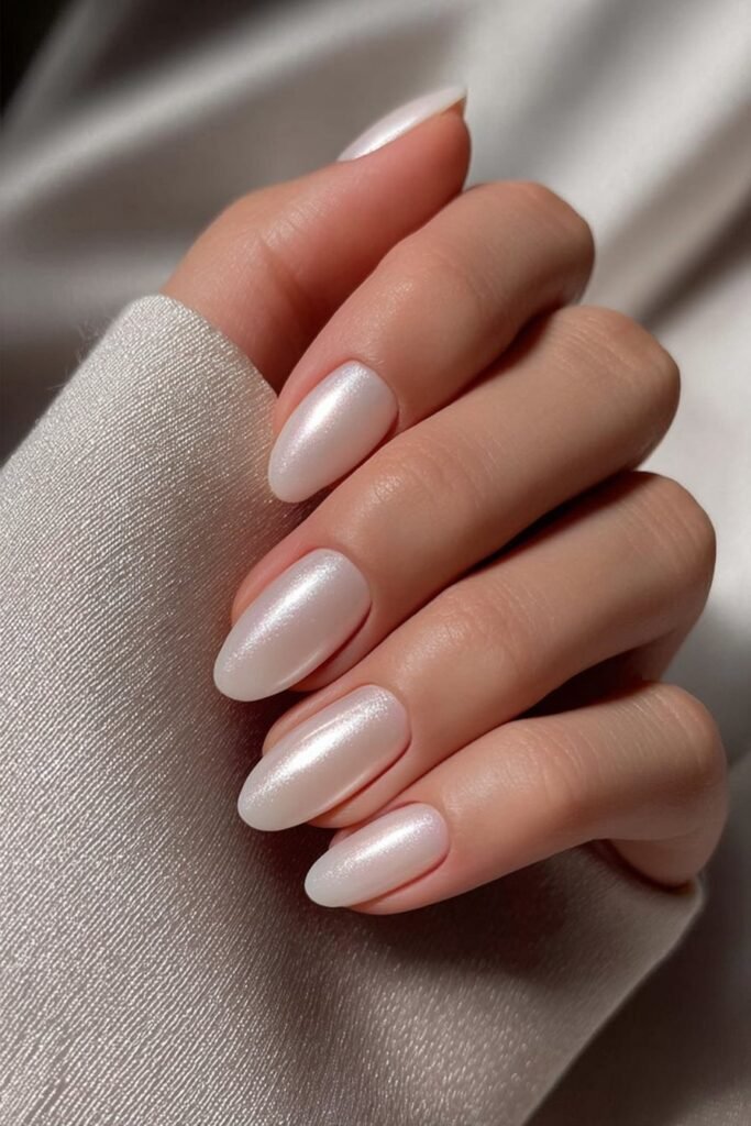 Pearl white nails with soft iridescent shimmer.